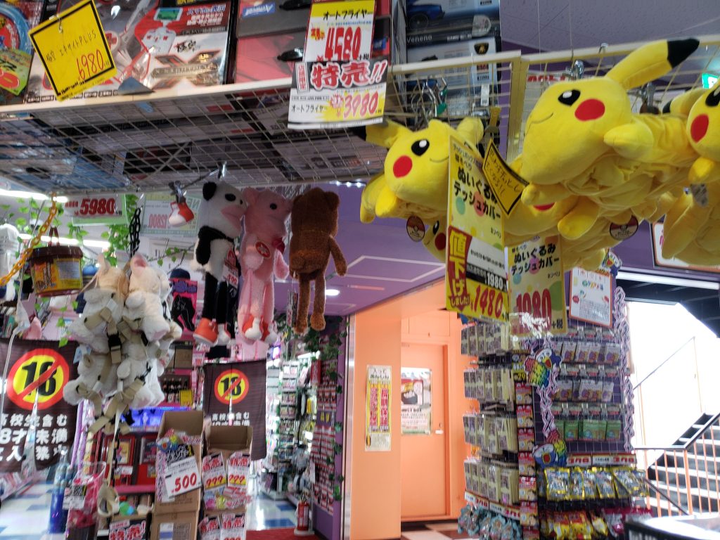 pikachu and other stuffed animals inside a don quijote