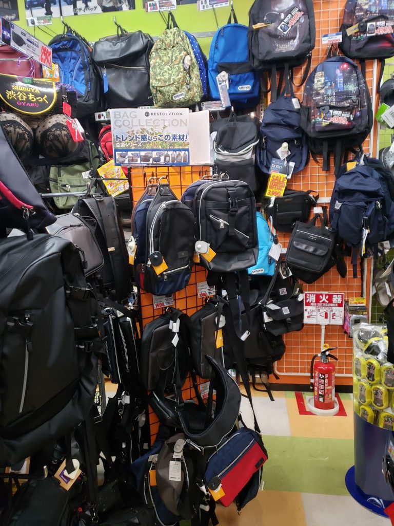 backpacks and other bags inside a don quijote