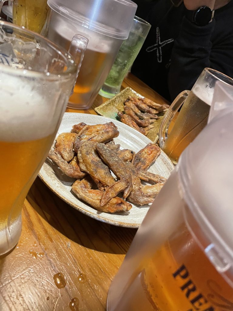 japanese chicken wings on a plate with beer