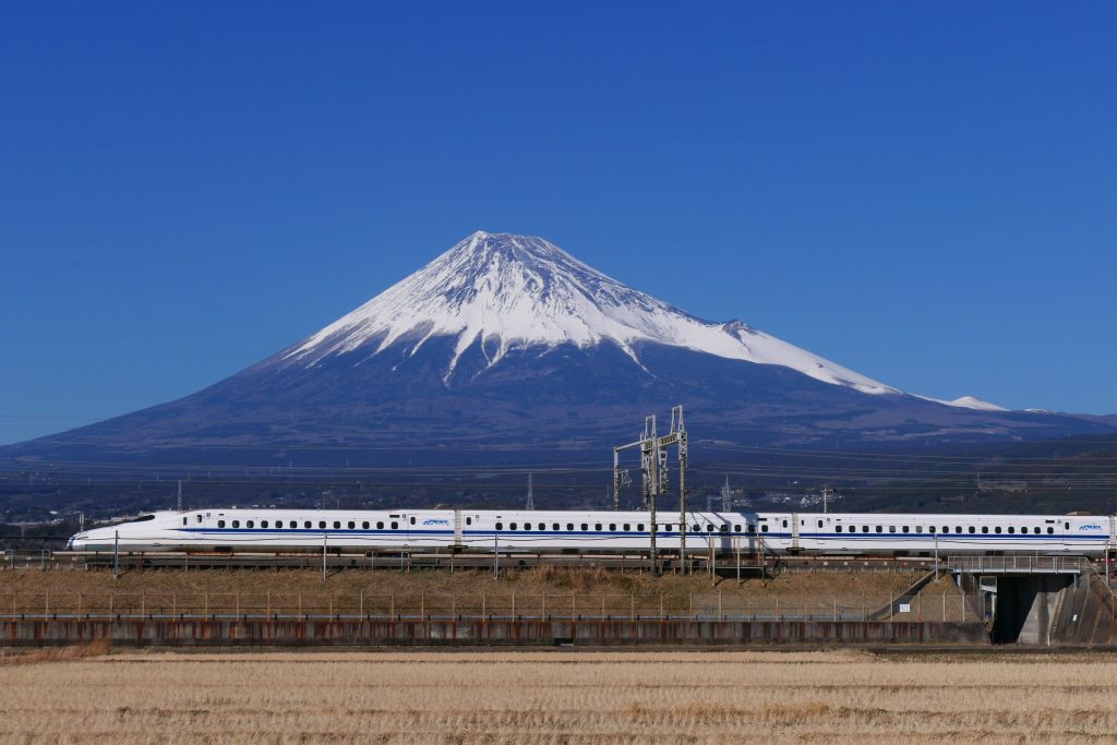 bullet train passing by in front of mt fuji